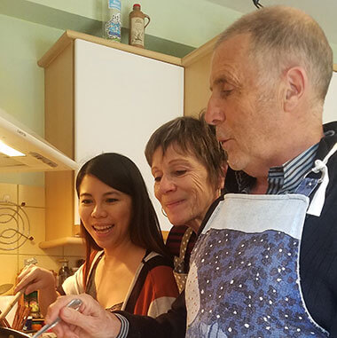 two women and one man cooking